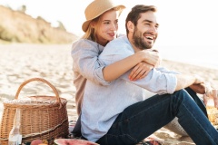 Cheerful young couple in love having picnic