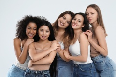 Group of women with different body types on light background