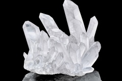 Pure Quartz Crystal cluster isolated on black background. Natural translucent crystal stone surface macro closeup. Macro of beautiful rare mineral stone