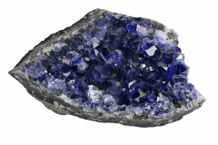 blue dark sapphire in geode on white