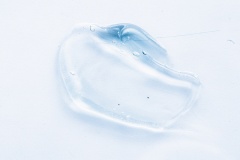 Transparent liquid gel cream smudge on white background