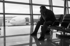 Sad man waiting for delayed flight in airport