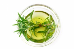 Rosemary oil isolated on white background. Top view.