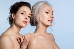 Elderly woman and young woman with perfect skin  and different age generation