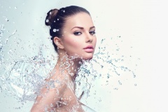 Beautiful spa woman with splashes of water