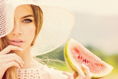 Gorgeous girl in crochet hat holding watermelon slice