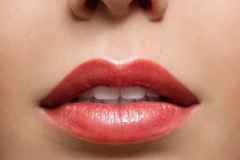 Close up of red glossy female lips